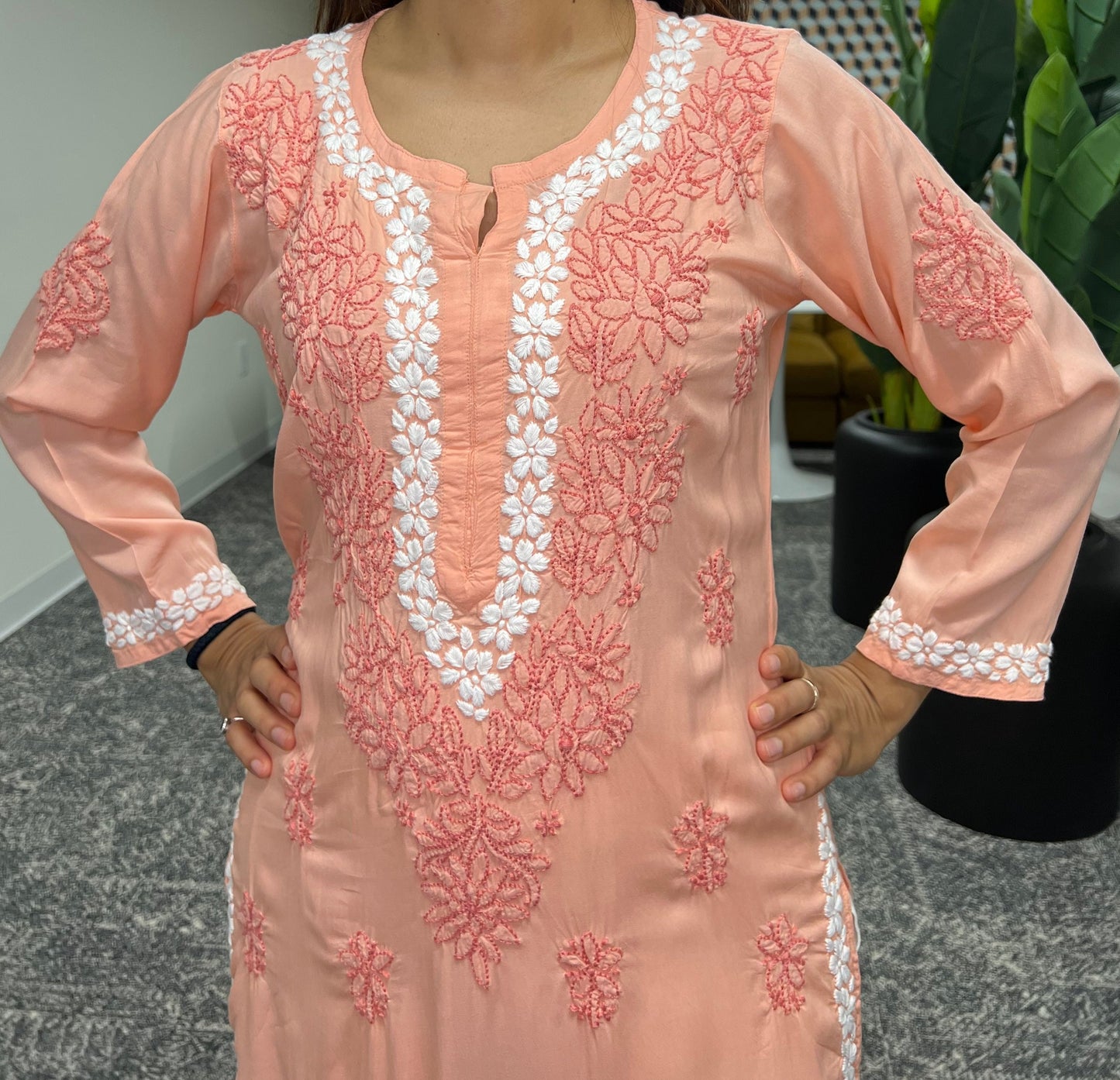 Chikankari floral border in white threads in neckline and floral bail and booti in dark orange threads